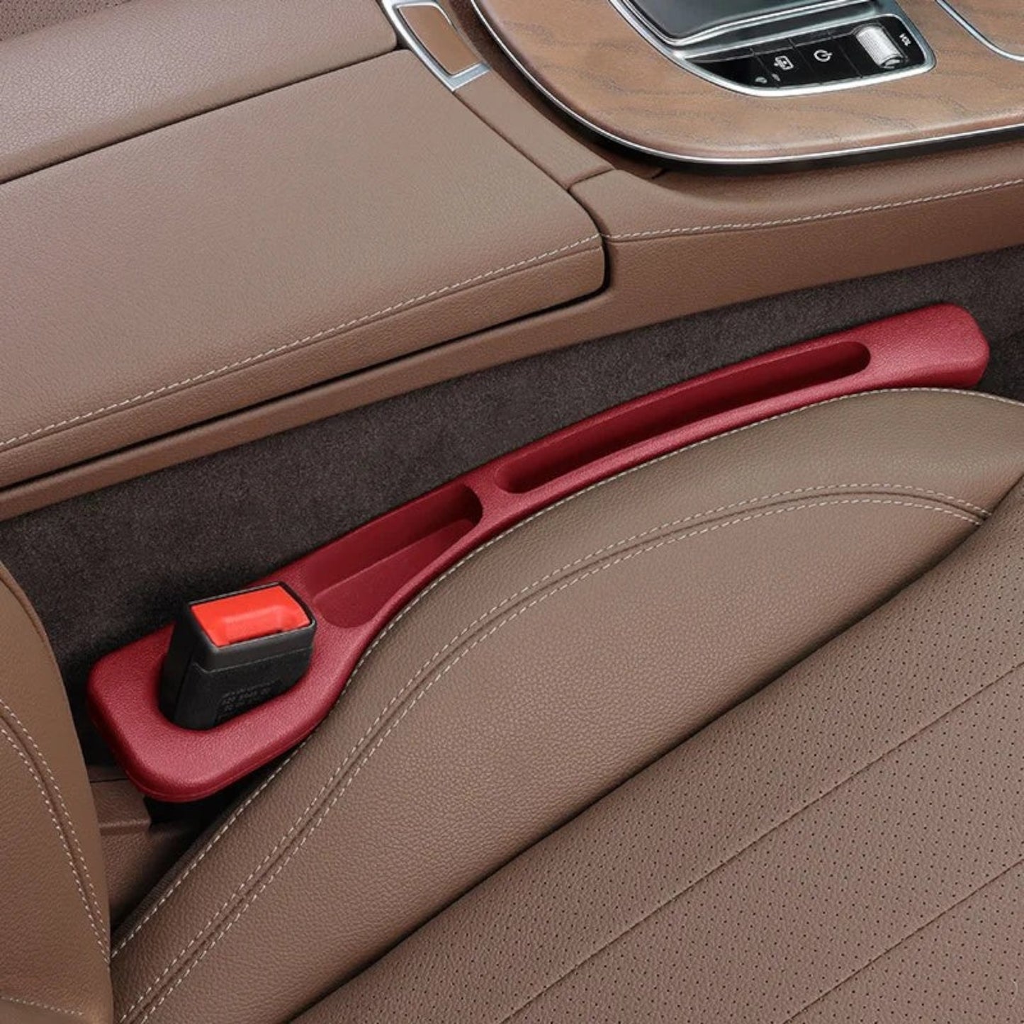Elevate Automotive red car seat gap organizer with built-in pockets and a seatbelt buckle.