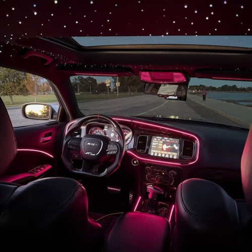 Elevate Automotive car interior with pink ambient lighting and starry night headliner.