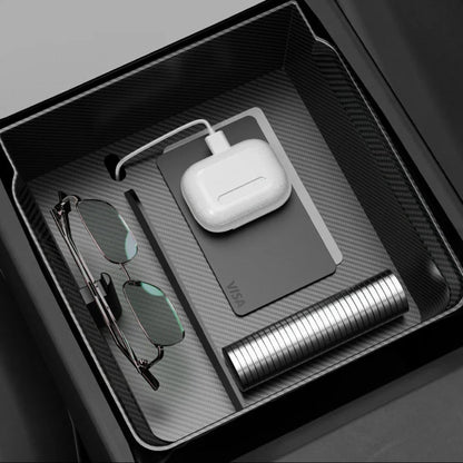 Elevate Automotive Tesla Model 3 Highland/Y Juniper center console organizer with carbon fiber finish, holding glasses, AirPods, and cards.