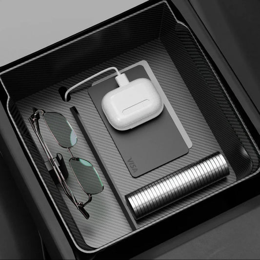 Elevate Automotive Tesla Model 3 Highland/Y Juniper center console organizer with carbon fiber finish, holding glasses, AirPods, and cards.